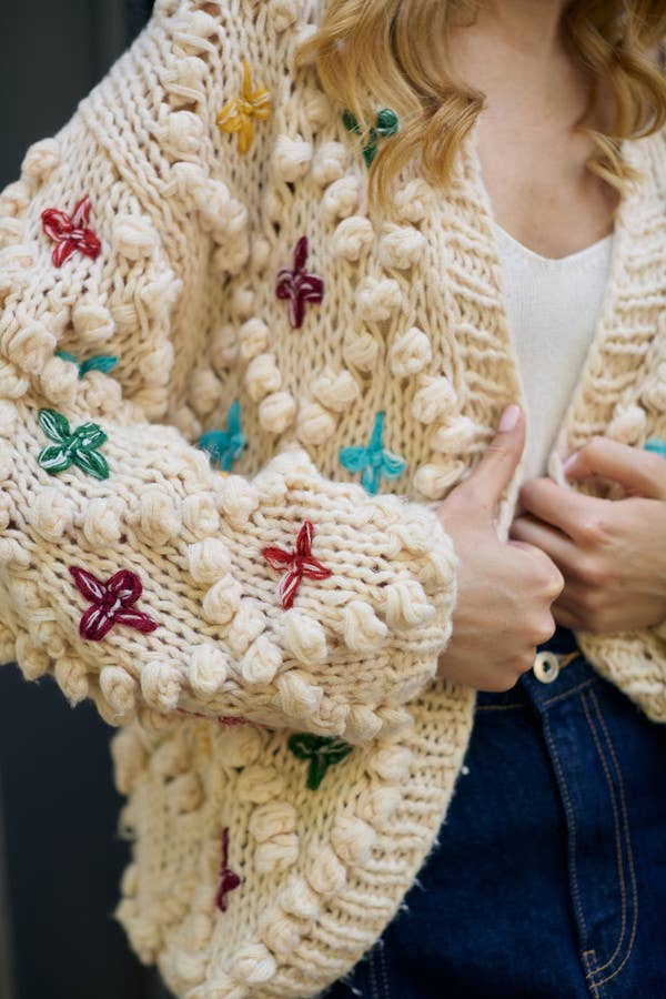 SAACHI - Knitted Cardigan Cross Pom Pom: IVORY